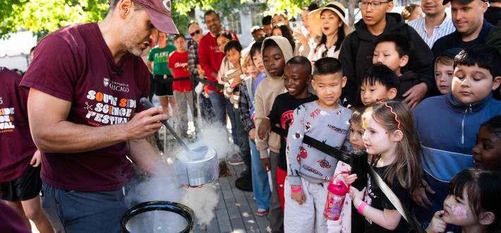 A scientist ladles vapor from a steaming container