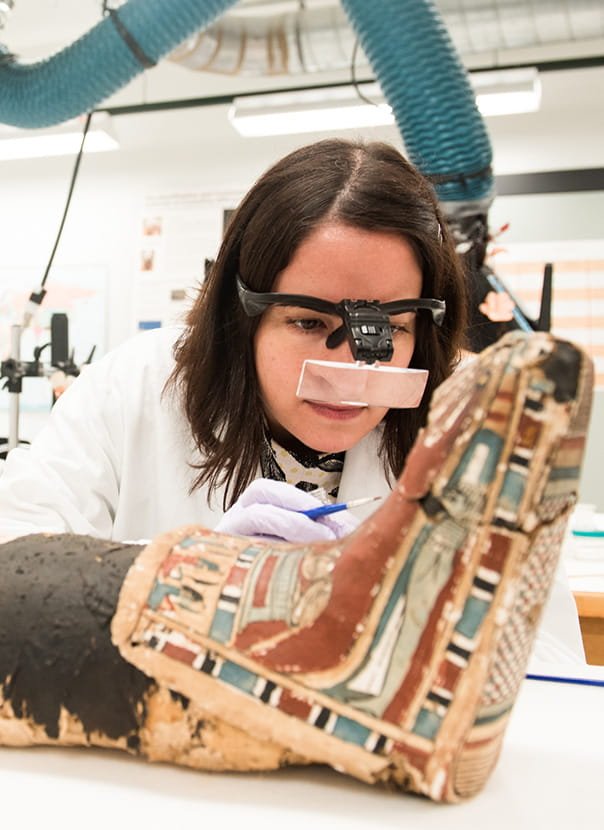 Alison Whyte works on a mummy for an exhibit